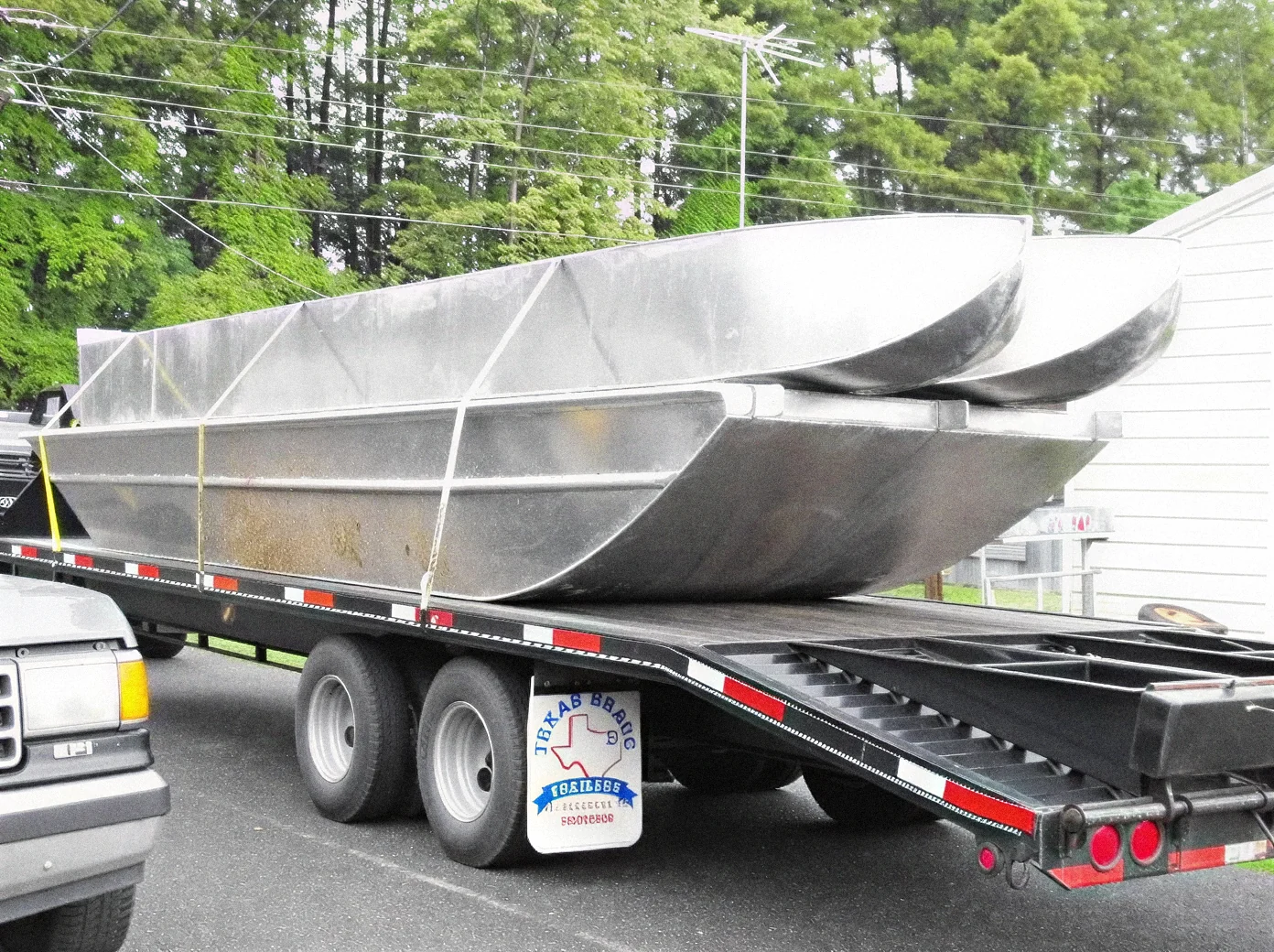 Fabricated aluminum hulls on a flatbed trailer
